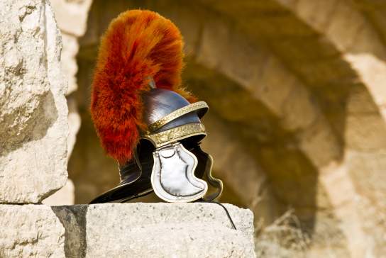 A centurion helmet displayed on roman ruins