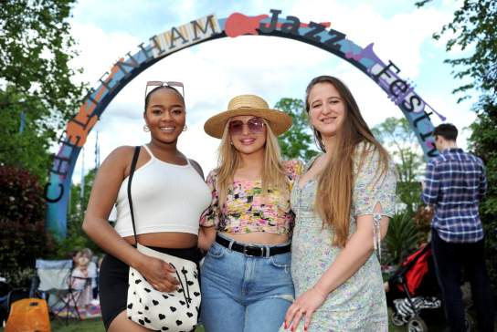 Ladies stood in front of the Cheltenham Jazz Festival sign in Montpellier Gardens, Cheltenham.