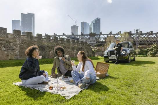 Friends enjoying a picnic in the sun in Castlefield