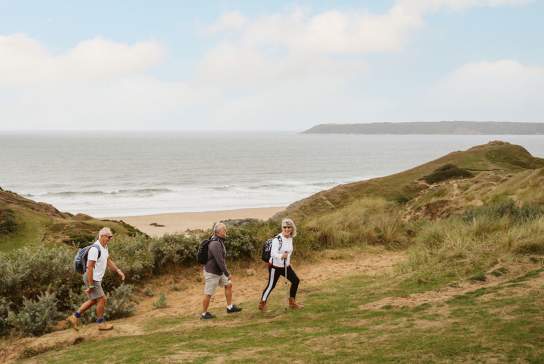 3 walkers in sand dunes