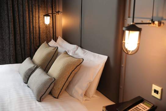 Modern, plush interior of a bedroom in the Titanic Hotel