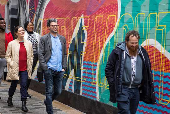 Group enjoying a street art walking tour with Seedhead Arts