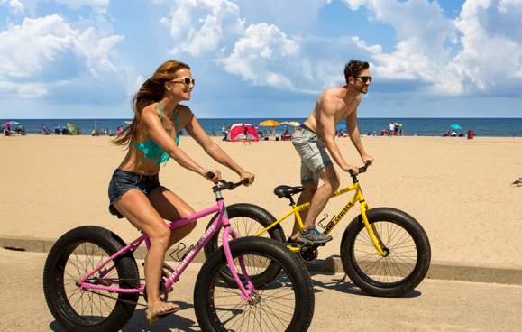 Couple biking by the beach