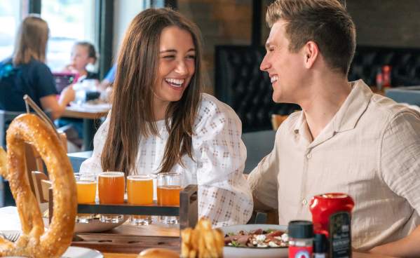 Couple enjoying beer and food at Grateful Goat