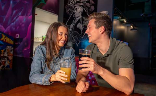 Couple enjoying draft beer and food at Lovedraft's