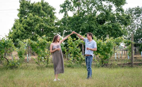 Couple dancing in front of grape vines at Totem Pole Ranch & Winery