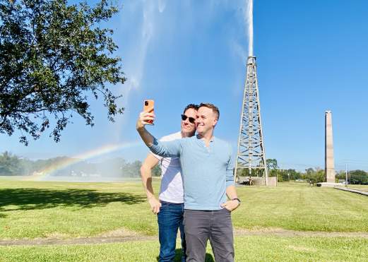 Couple taking selfie in front of the Spindletop Rainbow in Beaumont, TX