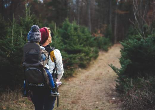 Woman hiking with toddler on her back in a carrier