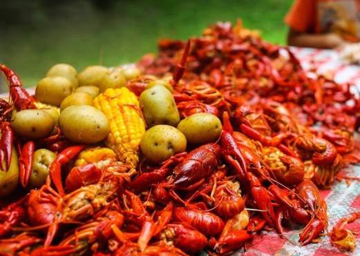 Crawfish have been prepared with corn-on-the-cob and potatoes for a community-style crawfish feast.