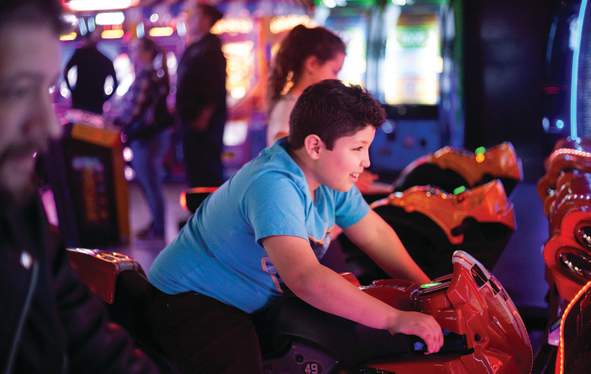 boy playing in an arcade