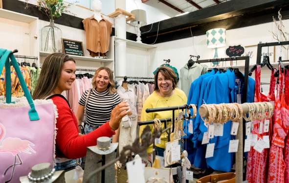 three ladies shopping in a boutique