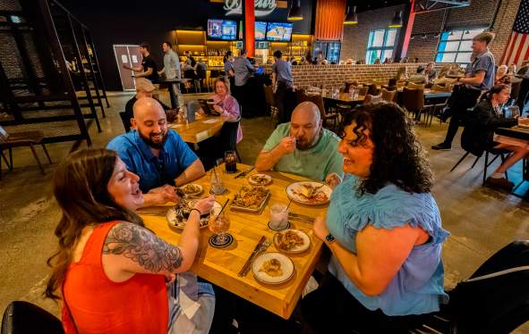 group of people enjoying food in a restaurant