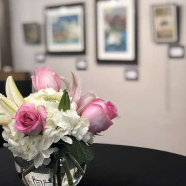 vase of flowers with art in background