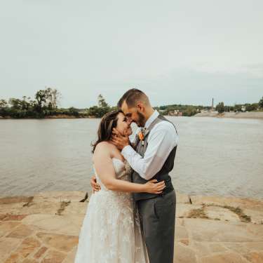 bridge and groom standing beside the river