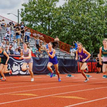 girls racing on an outdoor track