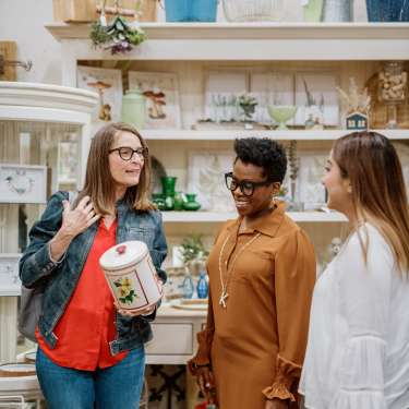 women looking at a canister in a store