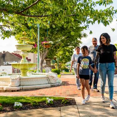 Hispanic family walking in a historic downtown