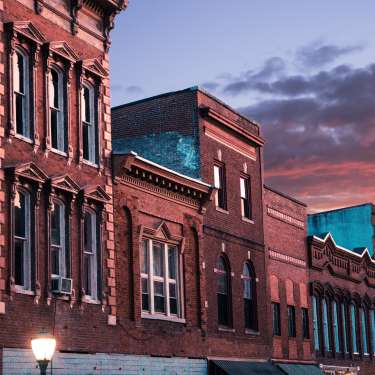 row of historic building tops at sunset