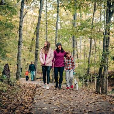 Family on trails in the fall time at Rotary Park