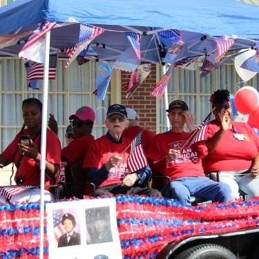 veterans riding on a trailer