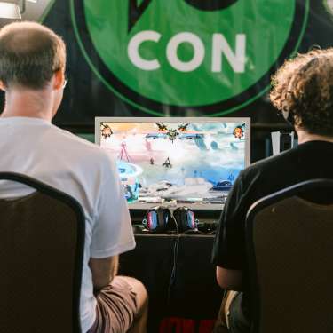 two players at a gaming console competing at F2CON in Clarksville, Tenn.