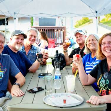 People enjoying drinks at the brewstillery concert.