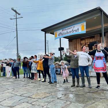 People holding mugs at oktoberfest