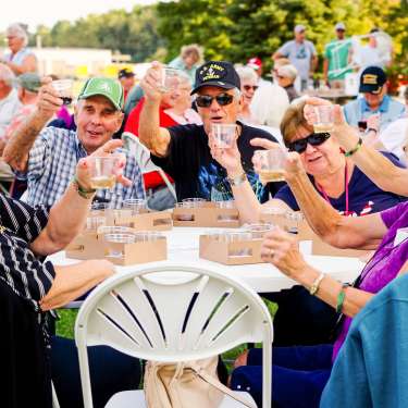 group of senior adults dining outside