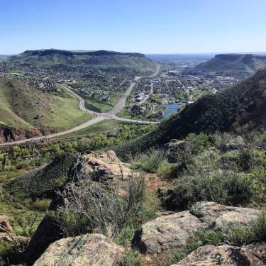 Aerial view of Golden CO and Highway 6 from Mount Zion by Lookout Mountain showing a scenic view of the mountains and mesas with the town far below.