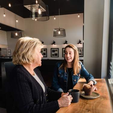 Two women talking over coffee