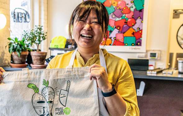 Chef Ji Hye Kim stands inside of Miss Kim