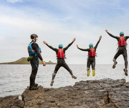 4 people jumping into the sea