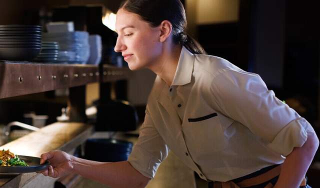 Restaurant worker pushing plated food out