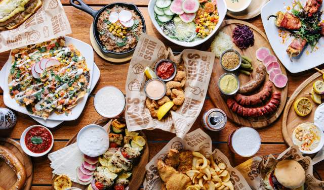 A spread of Huss Brewing's signature dishes, from crispy appetizers to mouthwatering mains, all paired perfectly with their craft brews.