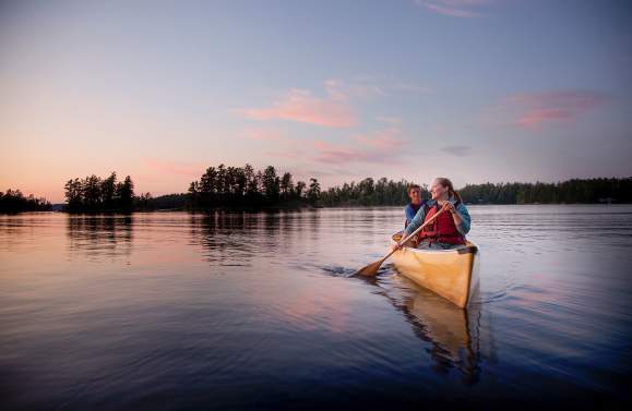 Two people canoeing on an inland lake