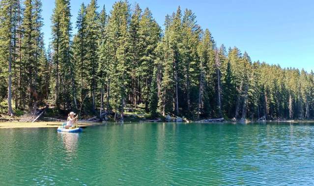 Woman Fly Fishing on a Paddleboard on The Grand Mesa