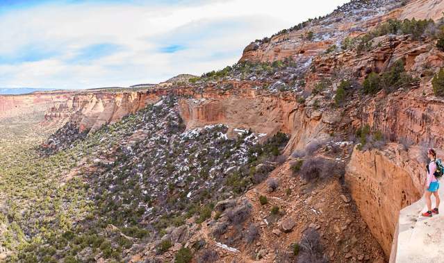 Woman stands at overlook in Colorado National Monument in the Winter