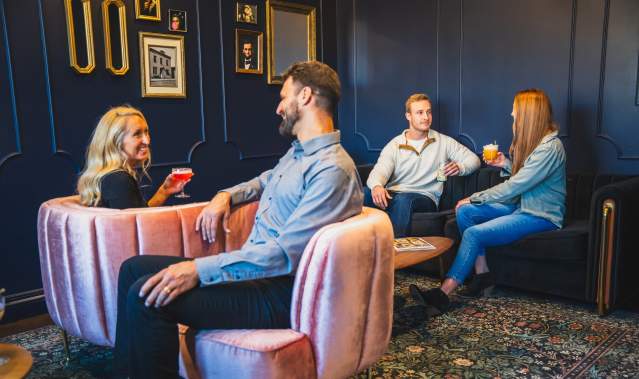 People Sitting in Lobby at Hotel Melrose