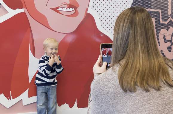 Mom and son taking photo at Montgomery Visitor Center mural.