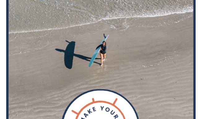 The cover of a map brochure with a surfing image and blue, orange, and white branding.