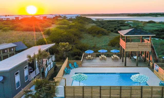 Aerial view of an RV park swimming pool, buildings, and observation deck