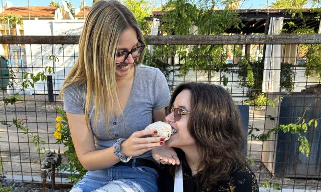 Female couple sharing a cinnamon roll