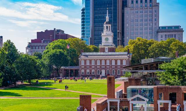 A large clock tower known as Independence Hall in Philadelphia on a sunny day