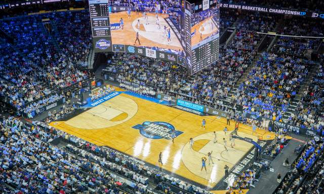 Aerial view of a basketball game being played at Xfinity Mobile Arena in Philadelphia with people in the stands