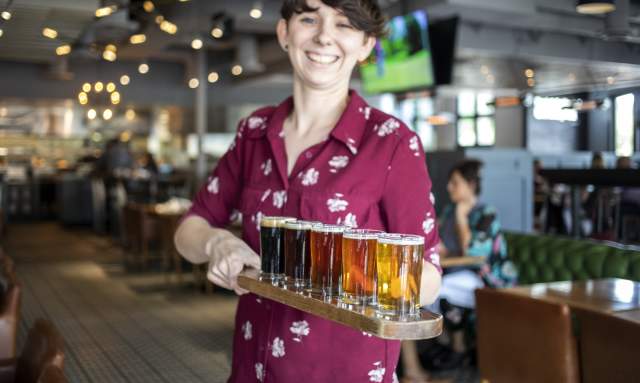Woman Serving Beer At Hop Social Tavern In Chandler, AZ
