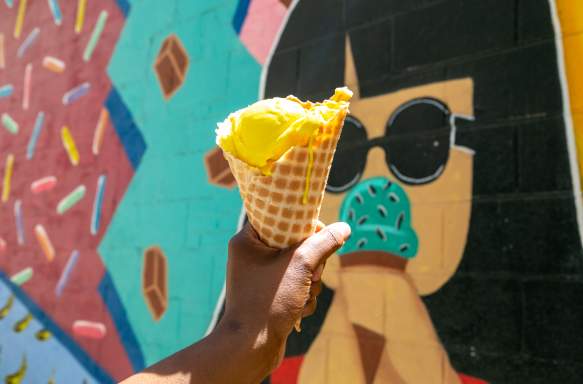 Chocolate Moose ice cream cone held in front of their mural