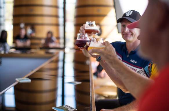 3 glasses of beer held up in the air at Upland Wood Shop