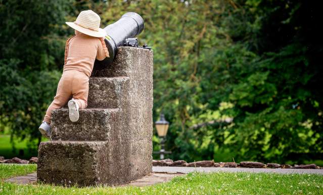 Young child climbing on canon in Tamworth Castle Pleasure Grounds