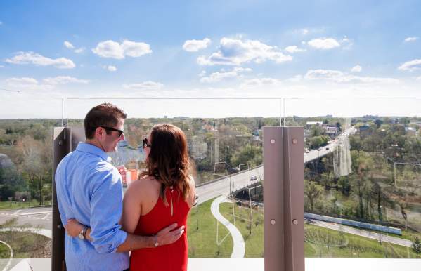Couple cheersing on the rooptop of VASO overlooking Downtown Dublin