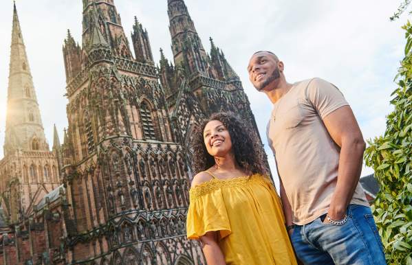 Couple outside Lichfield Cathedral on a sunny day